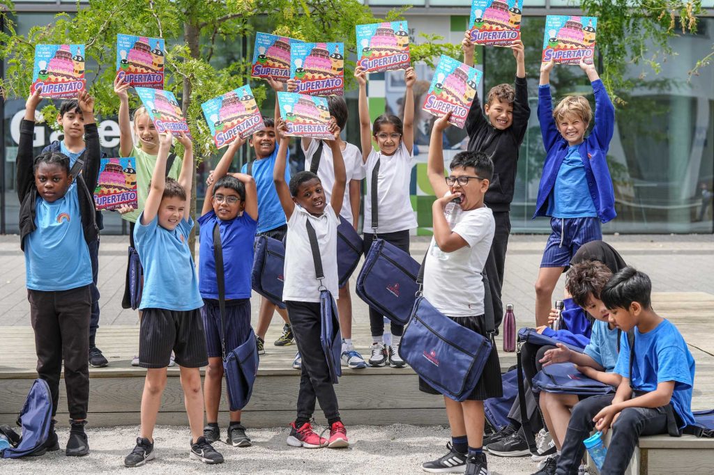 children holding up books